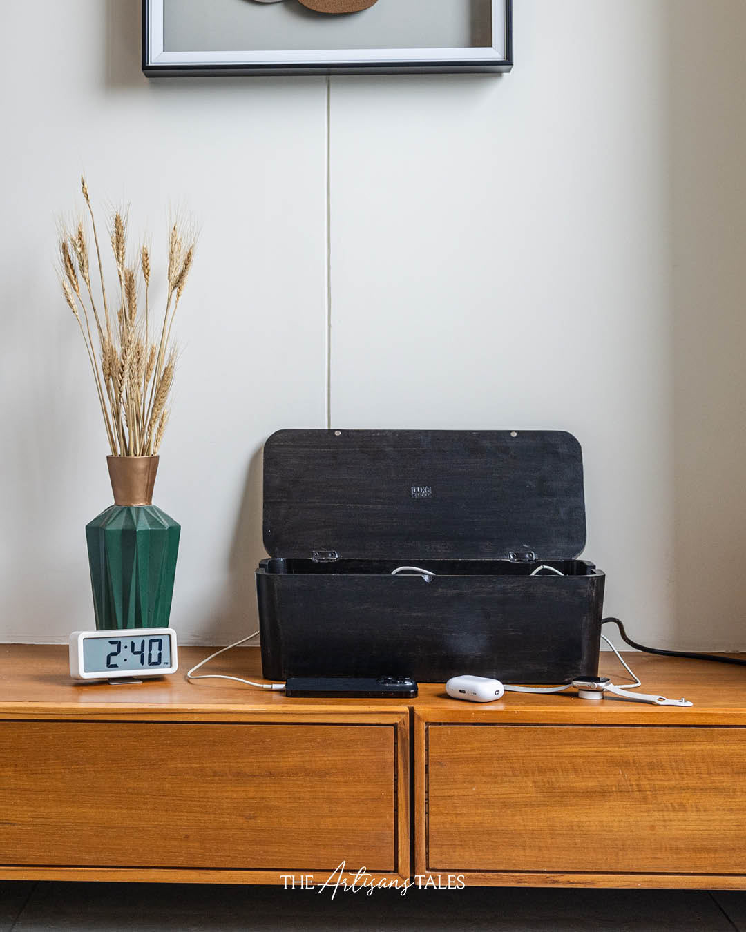 Black Mango Box with cables on a cabinet.