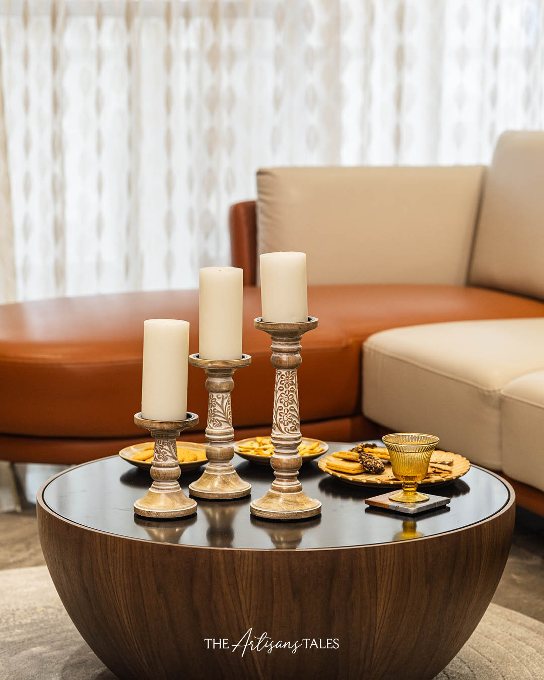 Three hand-carved candle holders made of mango wood with a natural brown finish,
