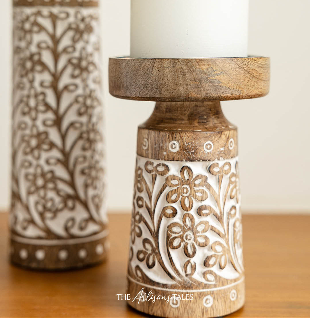 Hand-carved wooden candle holders with floral patterns.