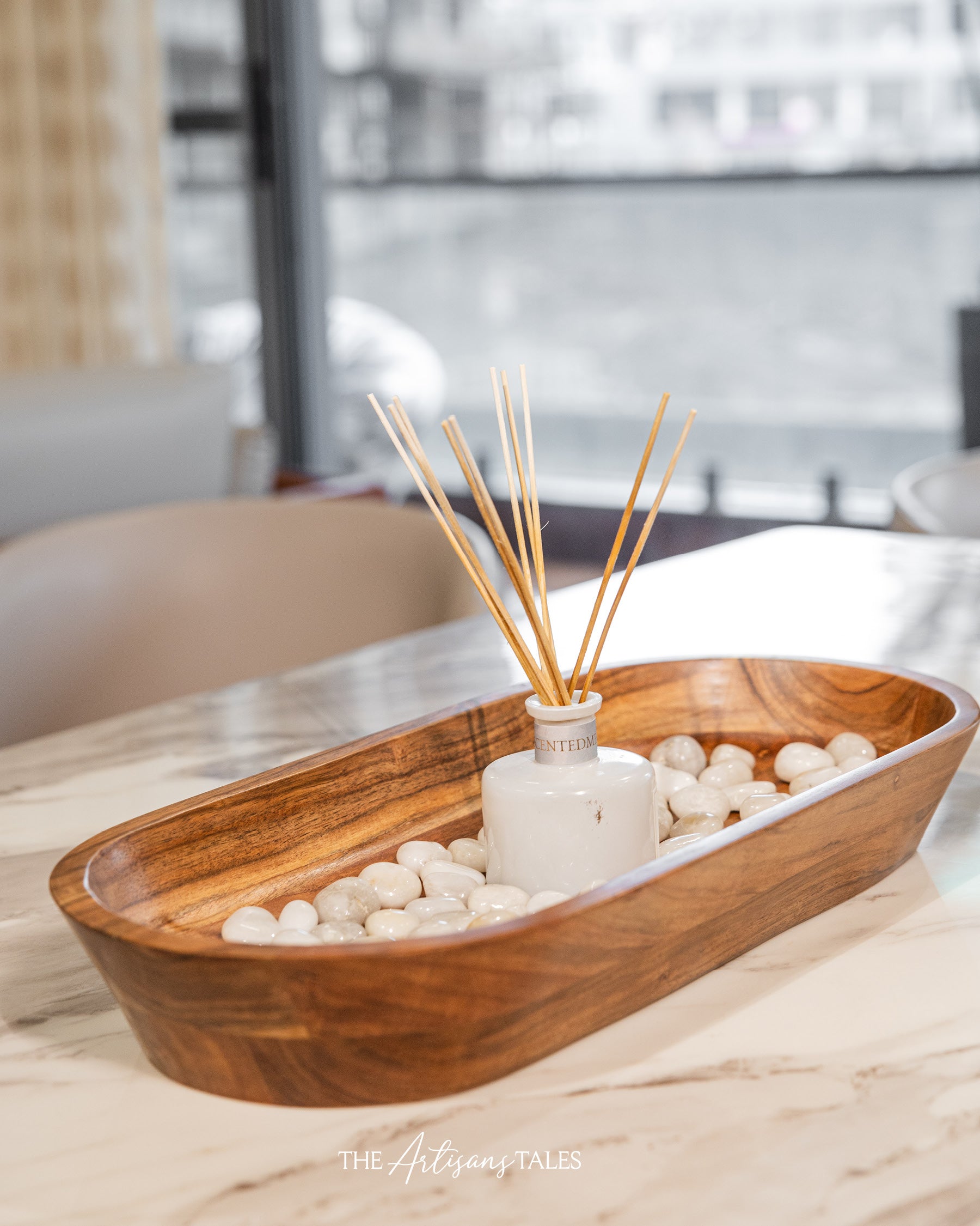 Wooden tray with reed diffuser and white stones