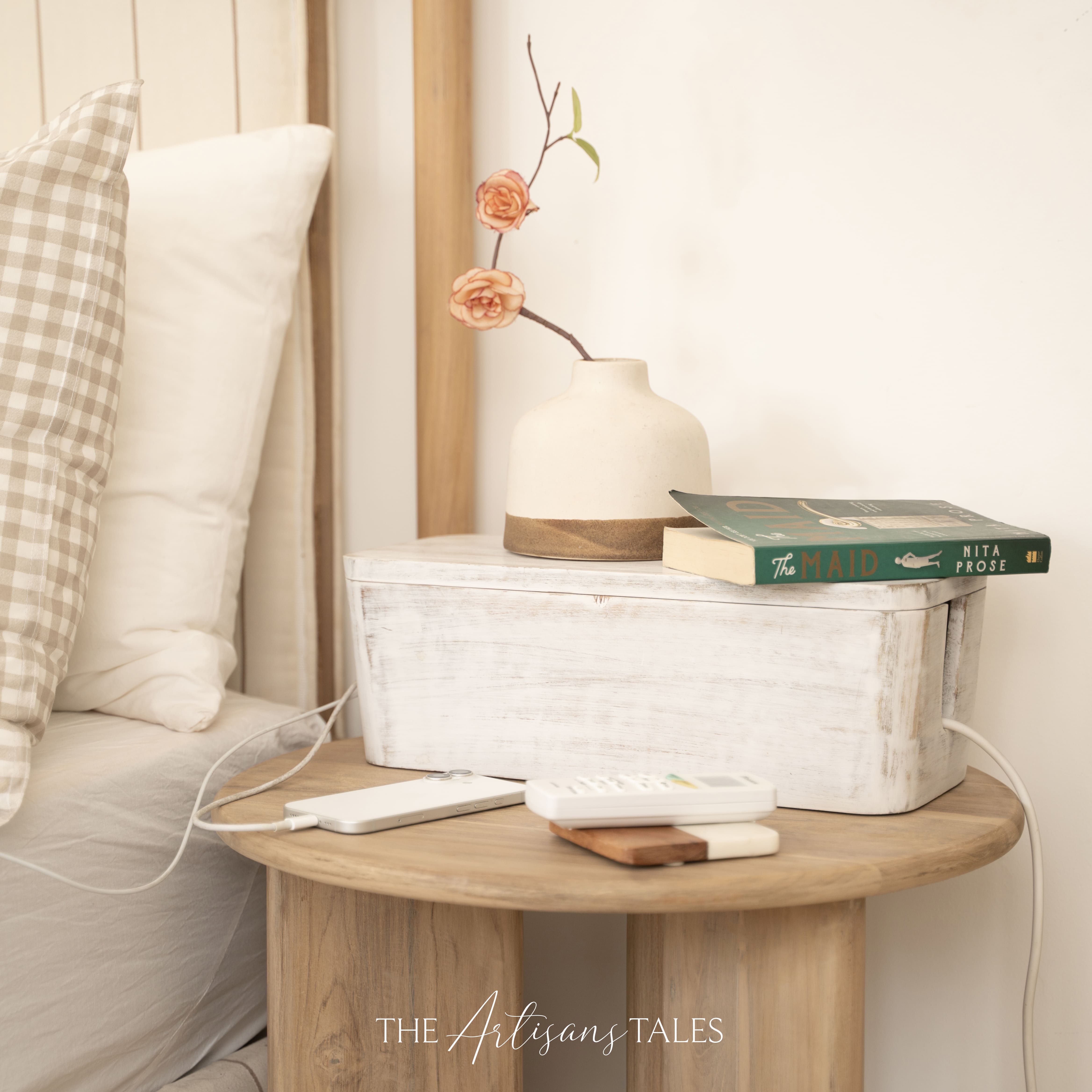 White handcrafted wooden storage box styled on a bedside table