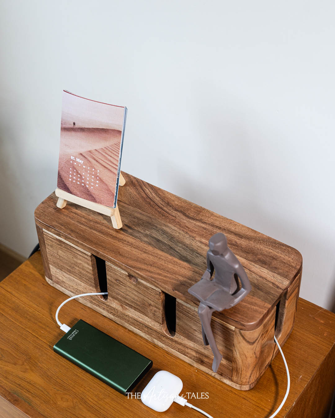 Acacia wood cable management box with phone charging setup.