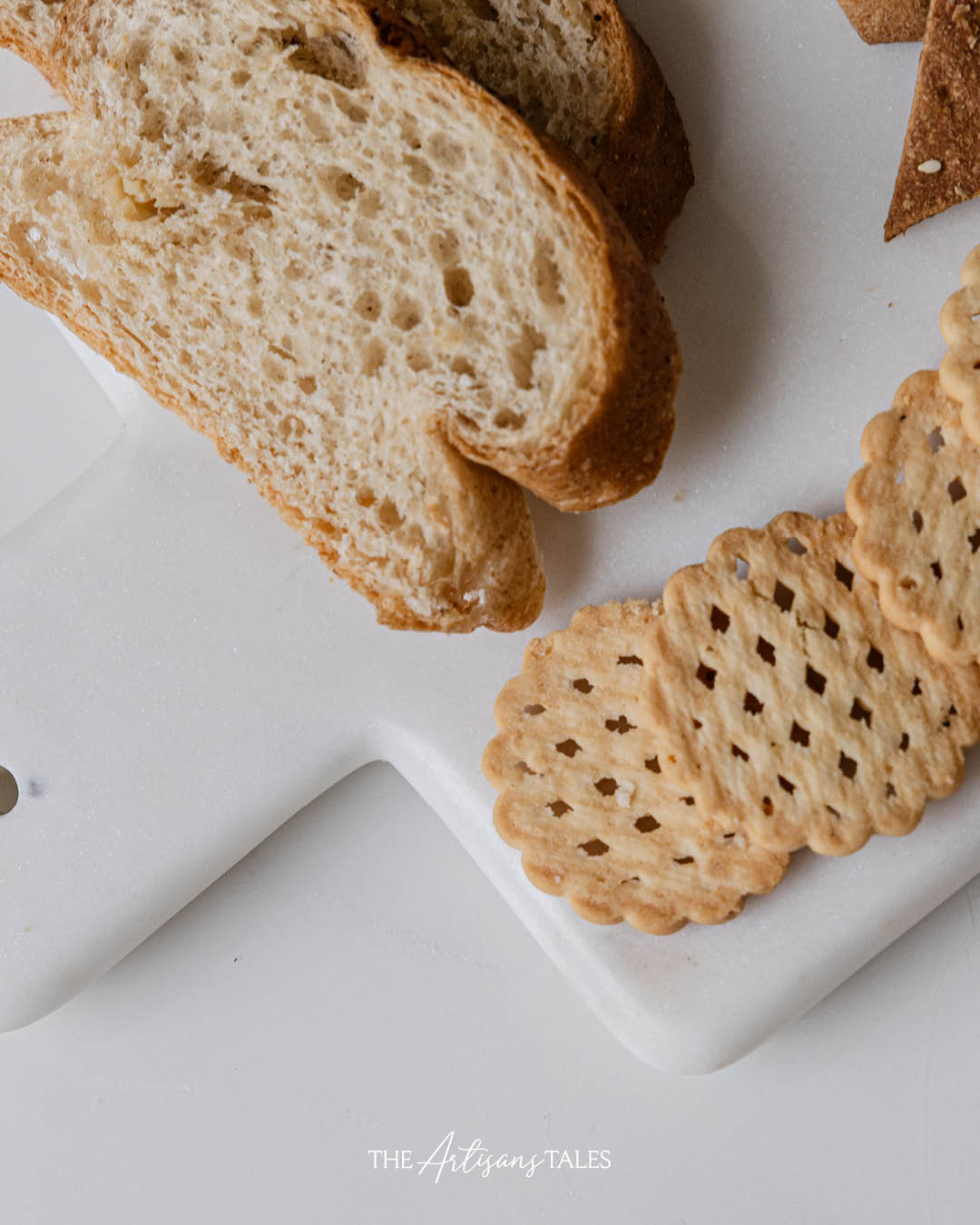 cheese serving board with crackers and bread