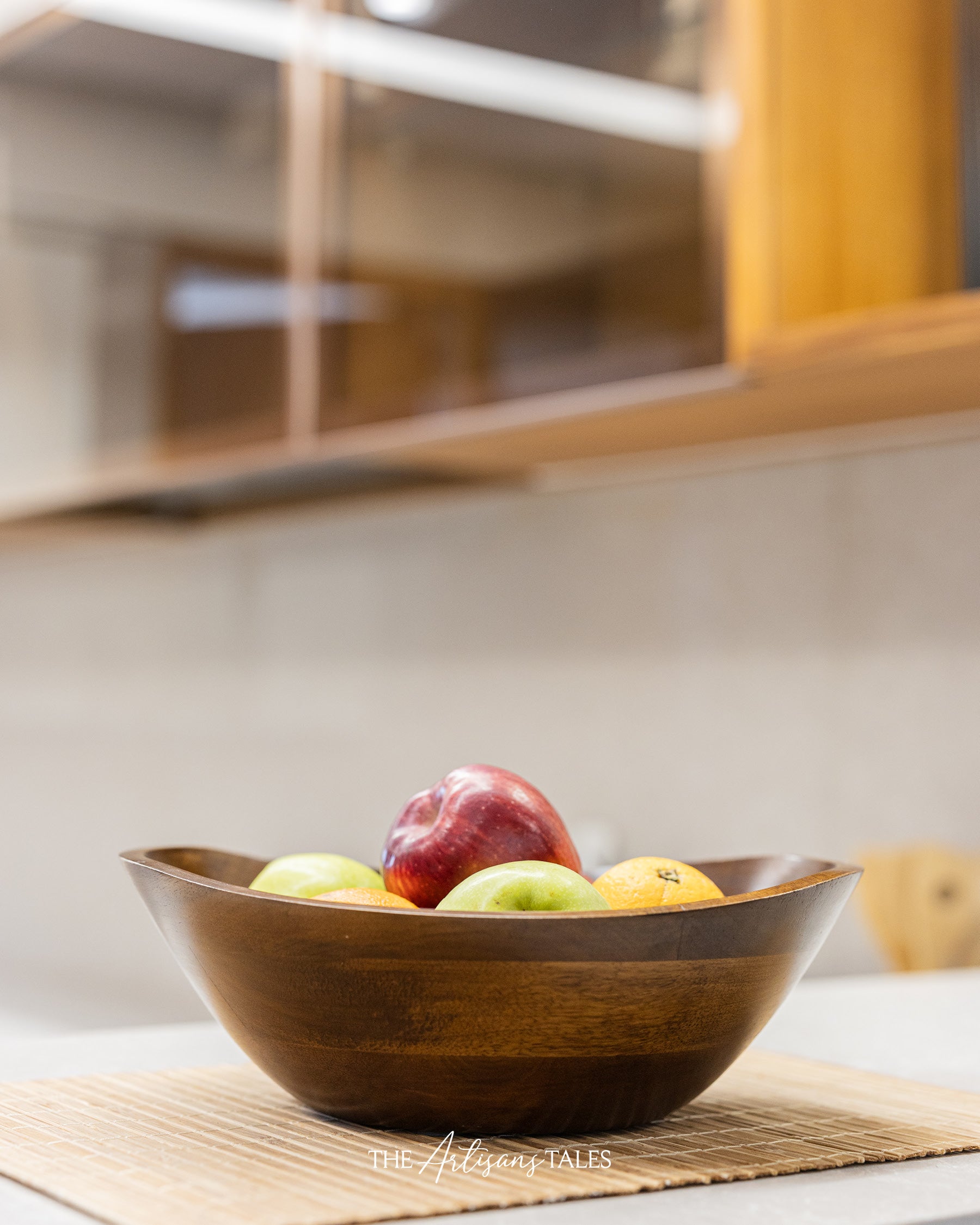 Curved wooden bowl with fresh fruits