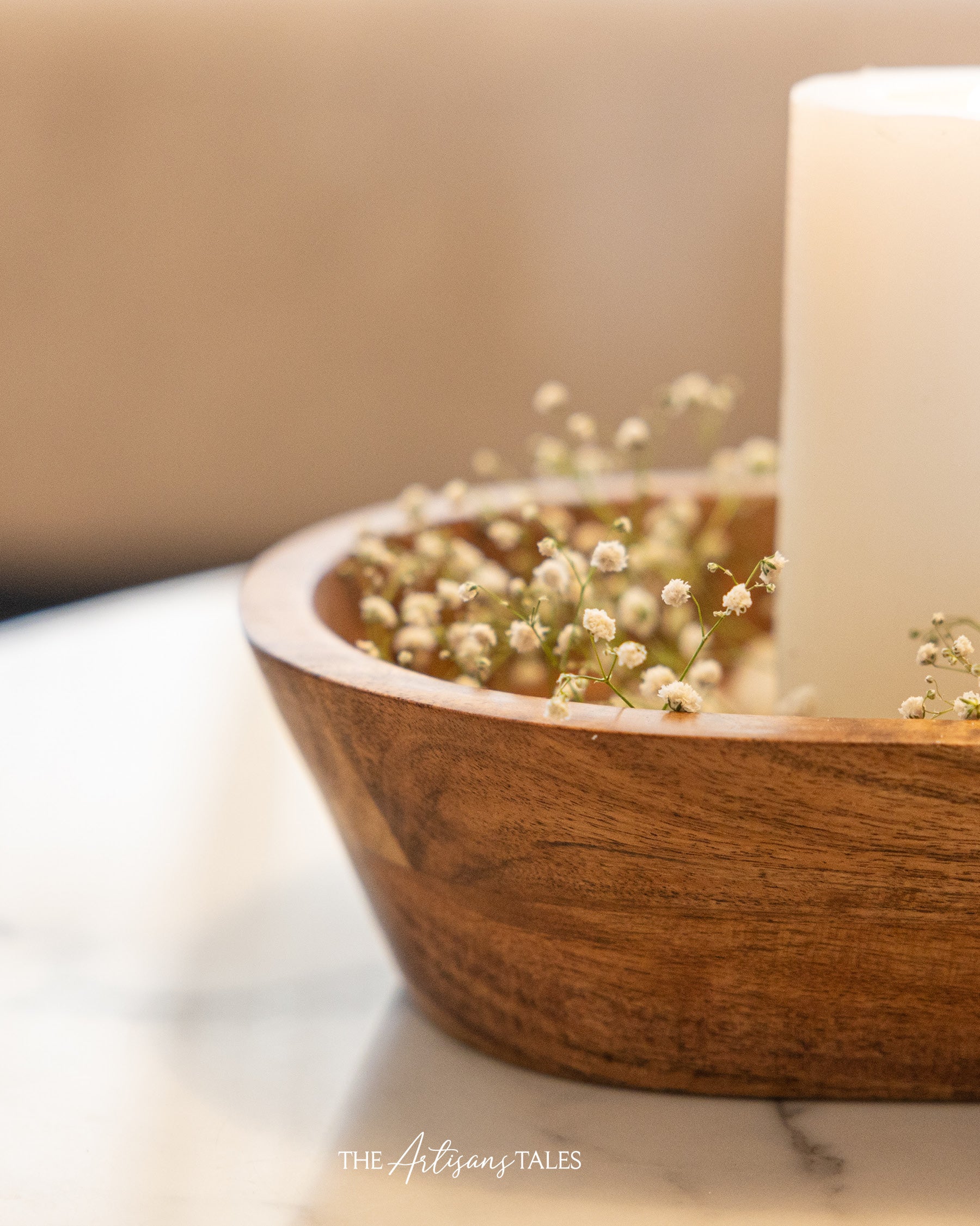 Candle with flowers in wooden bowl
