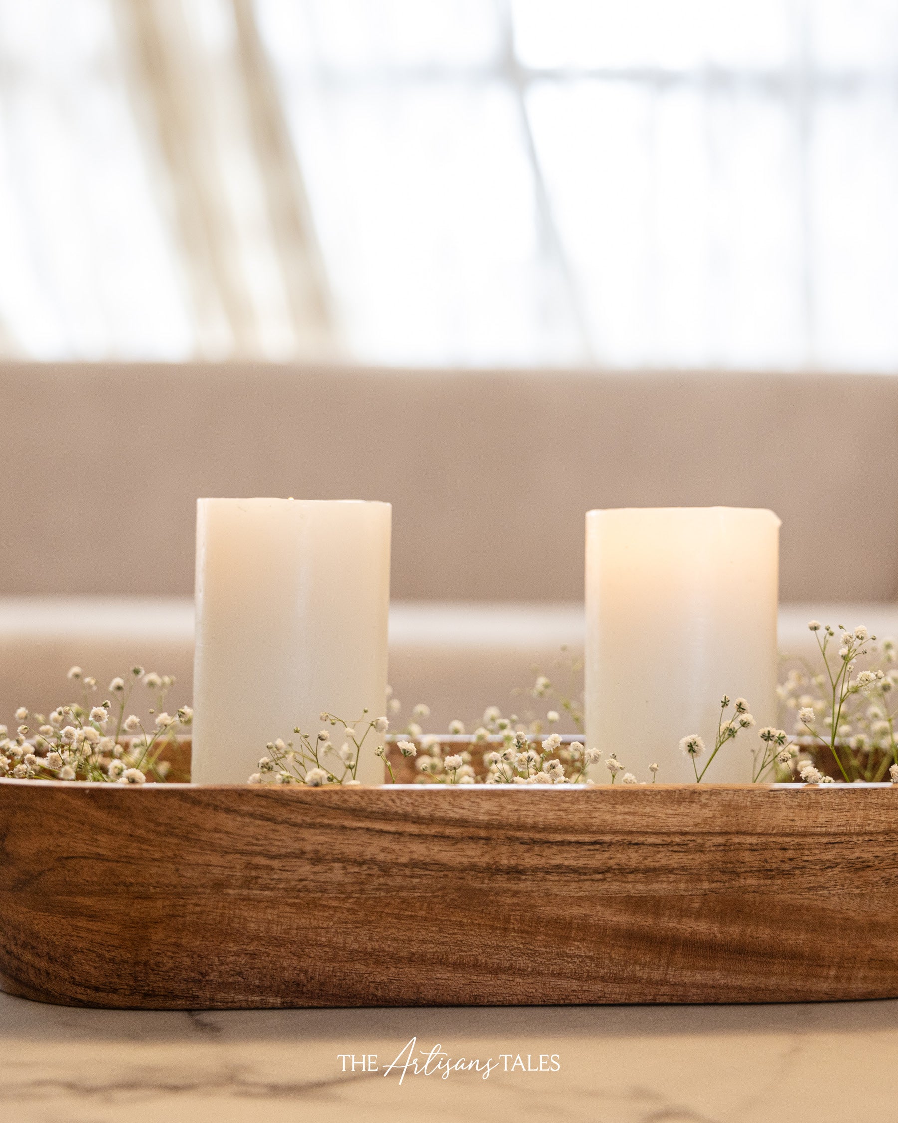 White candles in wooden tray